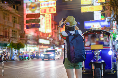 Photography hand of woman tourist taking of shot photo in Chinatown of Bangkok, Yaowarat famous and popular place with street food for tourist