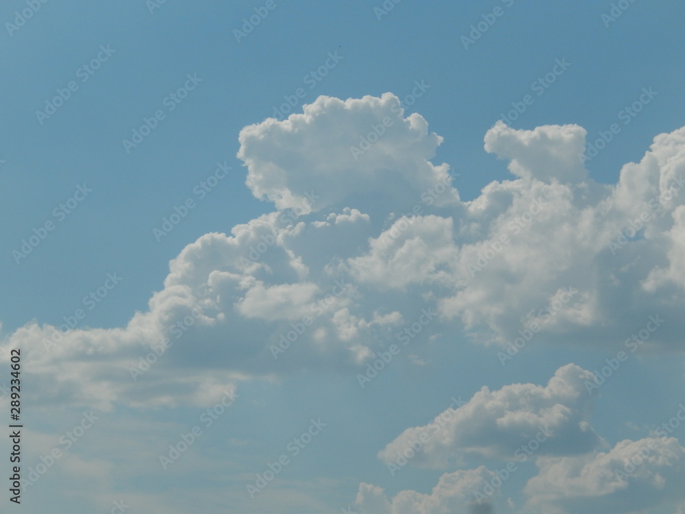 Cumulus clouds on a clear blue sky