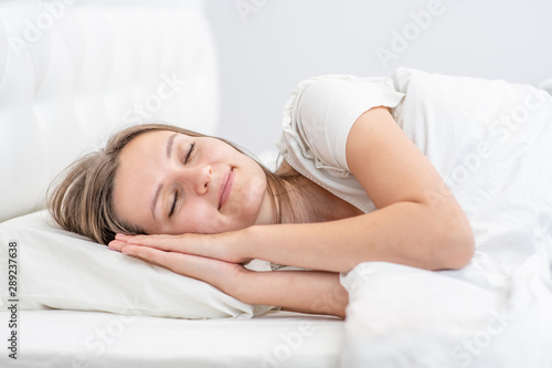 Beautiful smiling girl sleeps in the bedroom at home