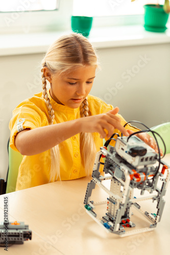 Girl making a robot using construction set.