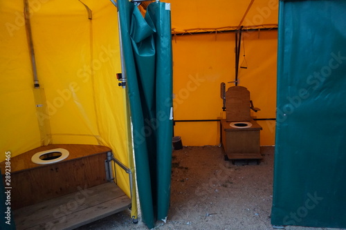 row of dry toilets at a festival © poupine