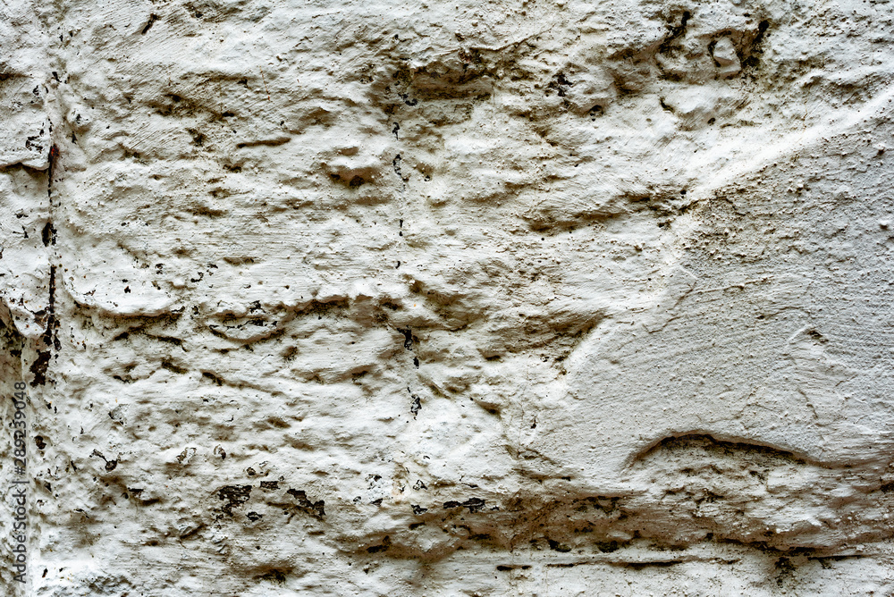 Texture of a concrete wall with cracks and scratches which can be used as a background Texture of a concrete wall with cracks and scratches which can be used as a background