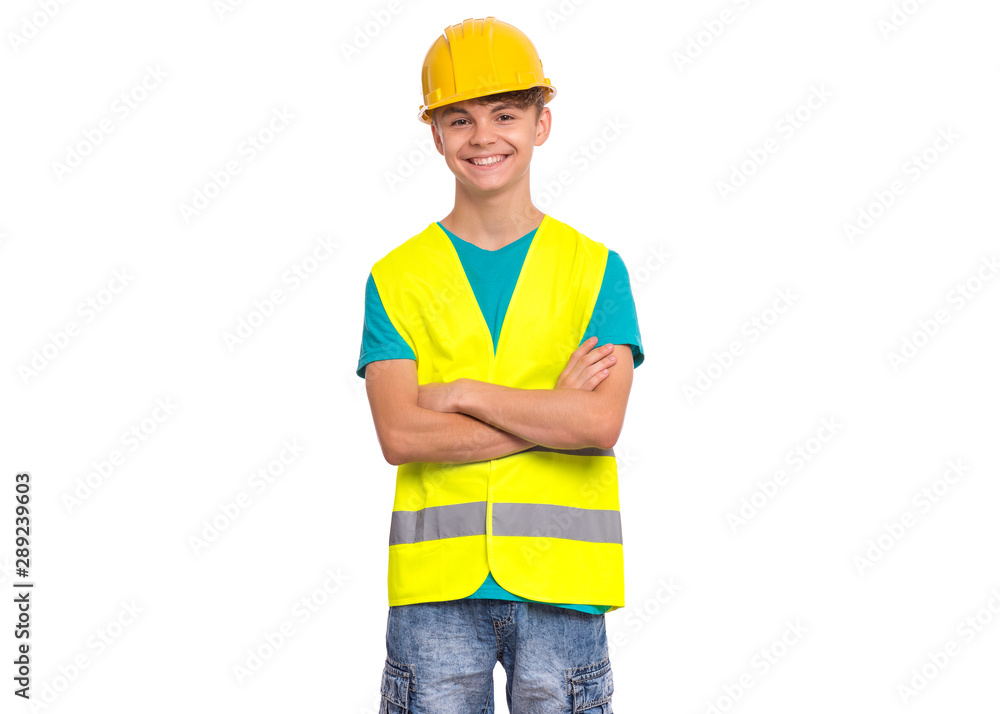 Funny Handsome Teen Boy wearing Safety Jacket and yellow Hard Hat. Portrait of Happy Child keeps arm folded and Looking at Camera, isolated on white background. Funny Handsome Teen Boy wearing Safety Jacket and yellow Hard Hat. Portrait of Happy Child keeps arm folded and Looking at Camera, isolated on white background.