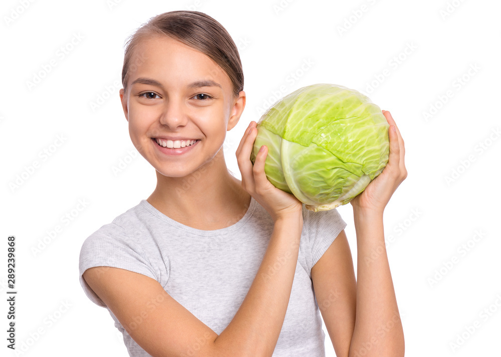 Beautiful young teen girl holding fresh green cabbage, isolated on white background. Portrait of smiling child showing delicious healthy raw vegetables in hands. Organic natural healthy food produce. Beautiful young teen girl holding fresh green cabbage, isolated on white background. Portrait of smiling child showing delicious healthy raw vegetables in hands. Organic natural healthy food produce.
