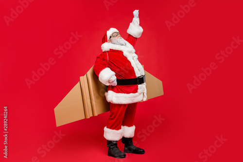 Ready set go. Full length photo of of grey-hair funky hipster super santa in goggles start his countdown fairy flight up fly wear cap hat pants belt isolated over red color background
