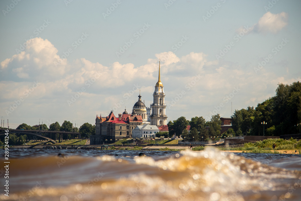 Rybinsk. View of the building of the grain exchange, the Holy Transfiguration Cathedral and the bridge over the Volga river. View from the river