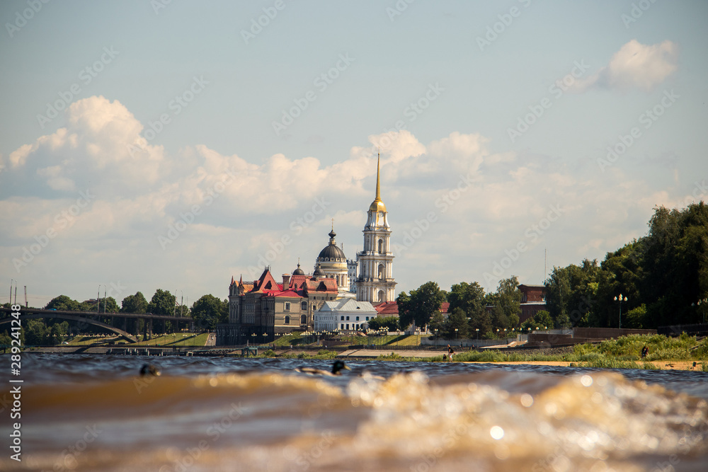 Rybinsk. View of the building of the grain exchange, the Holy Transfiguration Cathedral and the bridge over the Volga river. View from the river Rybinsk. View of the building of the grain exchange, the Holy Transfiguration Cathedral and the bridge over the Volga river. View from the river