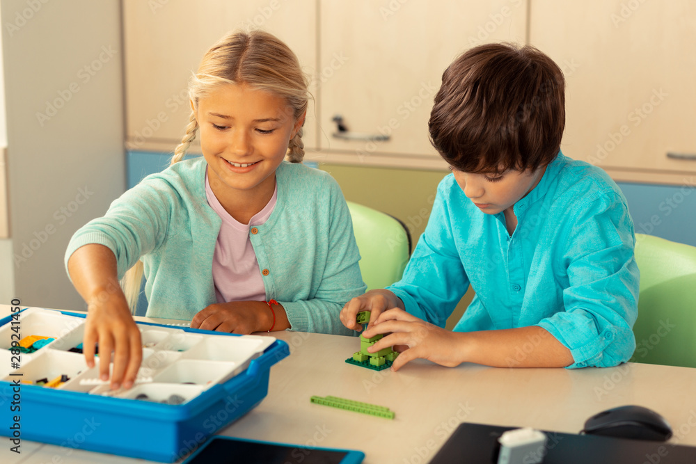 Classmates building figures during their school lesson. Classmates building figures during their school lesson.