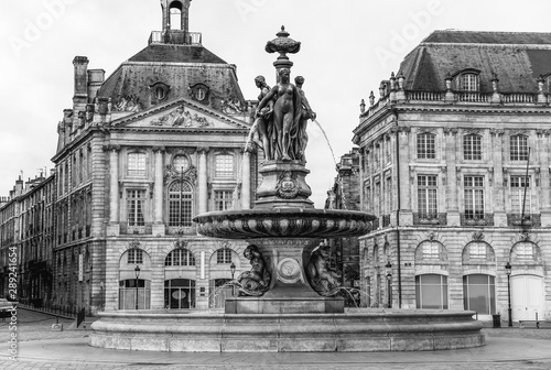 Fountain with Place De La Bourse in black and white photography, tourist attraction, Bordeaux city, Southern France.