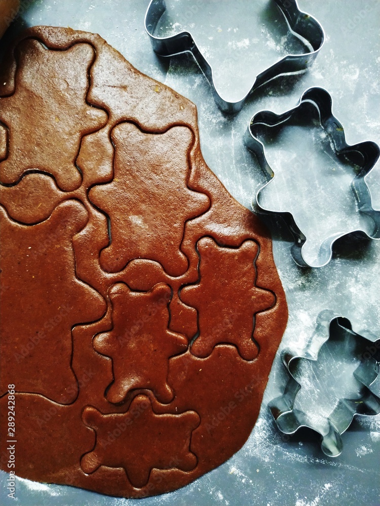 Preparation of ginger biscuits. A metal form in the form of gingerbread bear for cutting cookies. New Year's Eve symbol. Preparation of ginger biscuits. A metal form in the form of gingerbread bear for cutting cookies. New Year's Eve symbol.