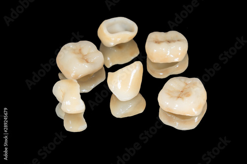 zirconium tooth crown macro. Isolate on a black background. Aesthetic restoration of tooth loss
