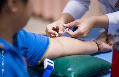 Thailand  Bangkok 2019 08 28. A health worker taking a blood sample from the vein by piercing the veinpunture and collecting blood into a test tube under negative pressure.