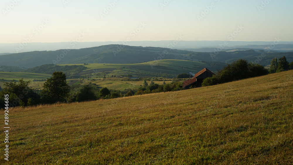 Grassland with farmhouse on the hill of White Carpathian, Czech Republic