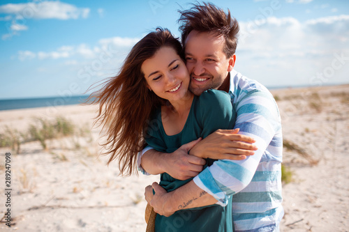 Young couple in love outdoor.Stunning sensual outdoor portrait of young stylish fashion couple posing in summer beach