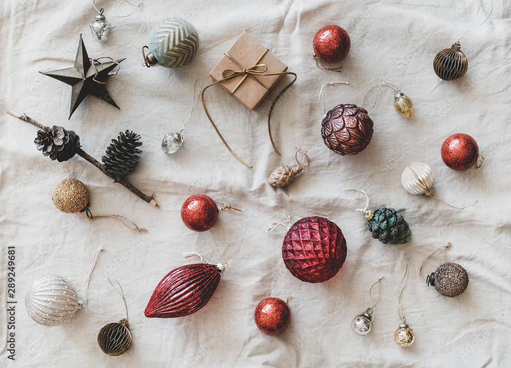 Christmas or New Year holiday background, texture and wallpaper. Flat-lay of Christmas festive decoration toys over beige linen cloth, top view. Preparation for winter holiday season Christmas or New Year holiday background, texture and wallpaper. Flat-lay of Christmas festive decoration toys over beige linen cloth, top view. Preparation for winter holiday season