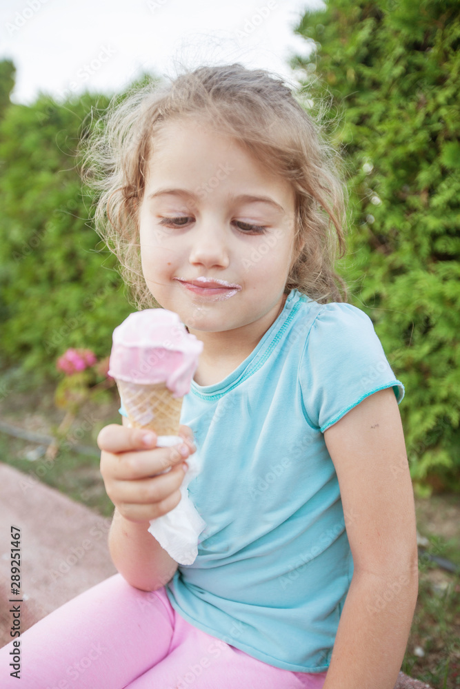cute smiling little girl eating ice cream cute smiling little girl eating ice cream
