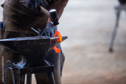 Farrier at work, fogging a horse..