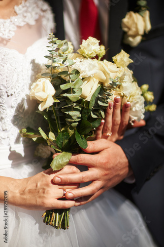 bride holds a wedding bouquet in her hands