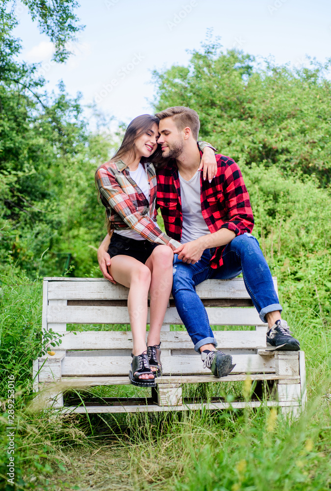 Couple in love sit on bench. Romantic date in park. Summer vacation ...