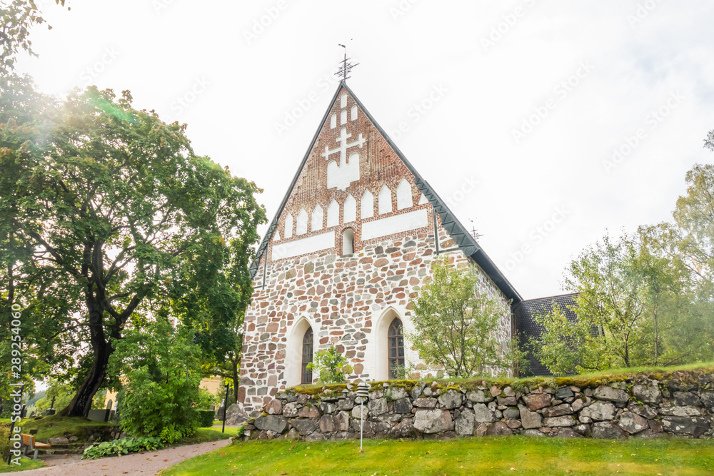 Fototapeta premium Hollola, Finland - 9 September 2019: Old medieval stone church of St. Mary in Hollola, Finland