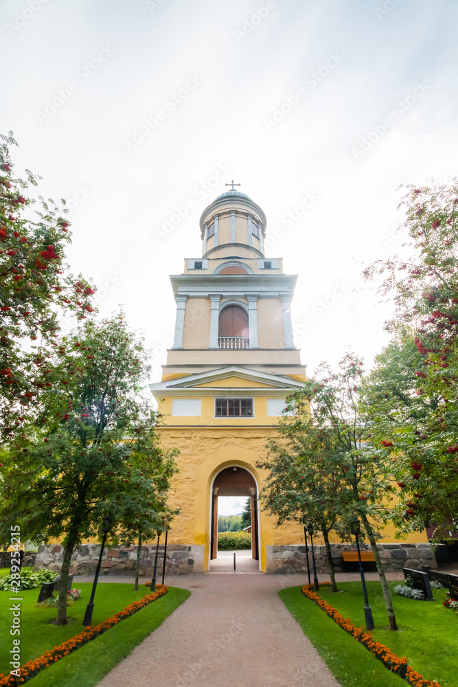 Hollola, Finland - 9 September 2019: Bell tower of old medieval stone church of St. Mary in Hollola, Finland