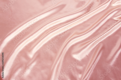 soft folds on delicate pink shining silk, luxury concept, background for the designer, horizontal, close-up, copy space