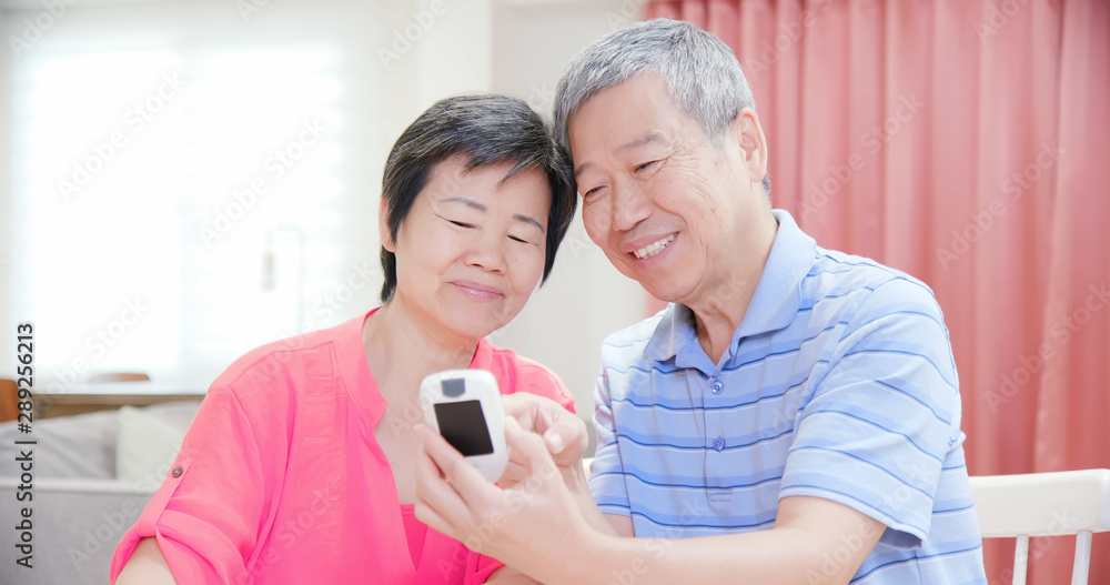 elder couple measure blood glucose elder couple measure blood glucose