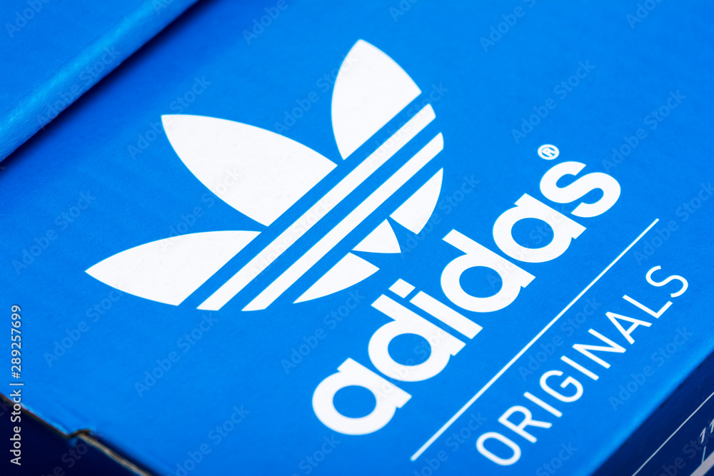 BUCHAREST, ROMANIA - JULY 23, 2014: Adidas Sign On Adidas Shoe Box. Founded  in 1924 is a German multinational corporation that designs and manufactures  sports shoes, clothing and accessories. foto de Stock | Adobe Stock