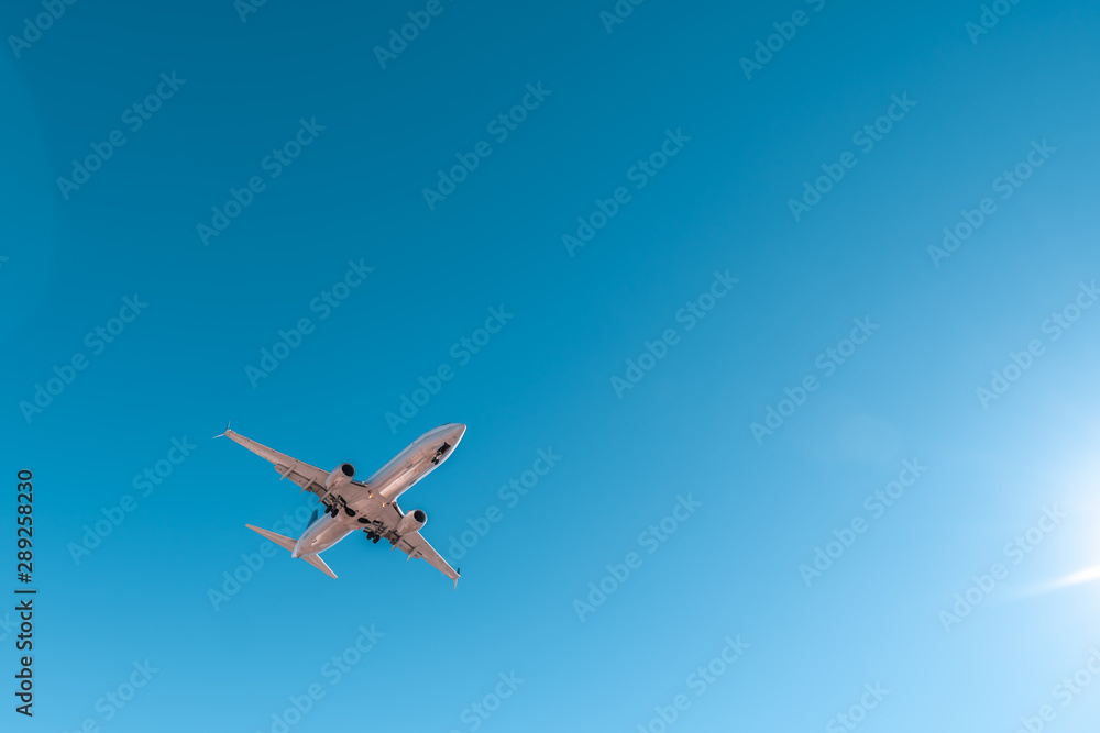 Obraz premium Aviation, travel, air transportation concept. Airplane in blue sky