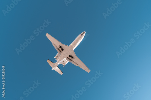 Aviation, travel, air transportation concept. Business jet in blue sky