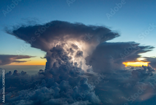 Schilderij op canvas Thunderstorm with some lightning during sunset