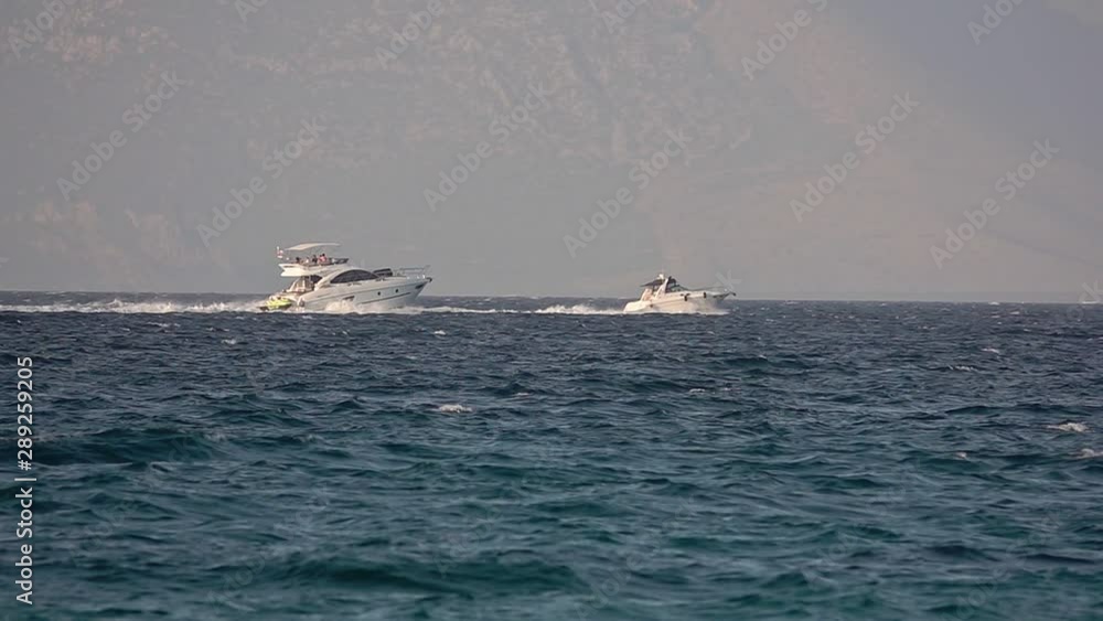 Motorboats At Sea stock video shows two ships sailing side by side in Turkey. Motorboats At Sea stock video shows two ships sailing side by side in Turkey.