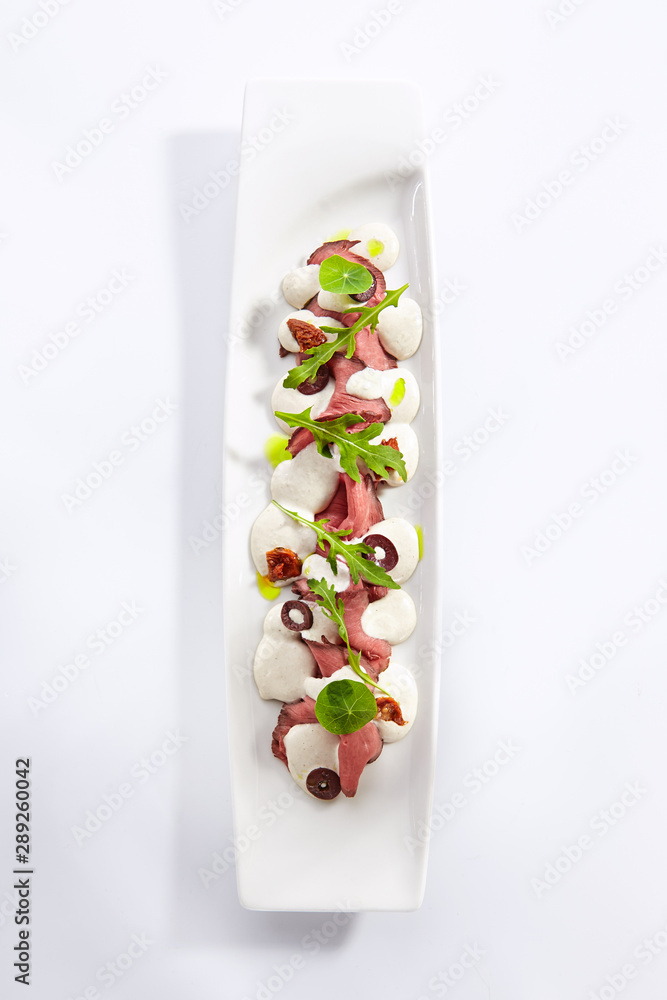 Beef vitello tonnato platter top view Beef vitello tonnato platter top view