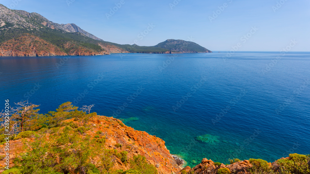 view from a sea cape to the marine, emerald sea gulf between rocky coastline