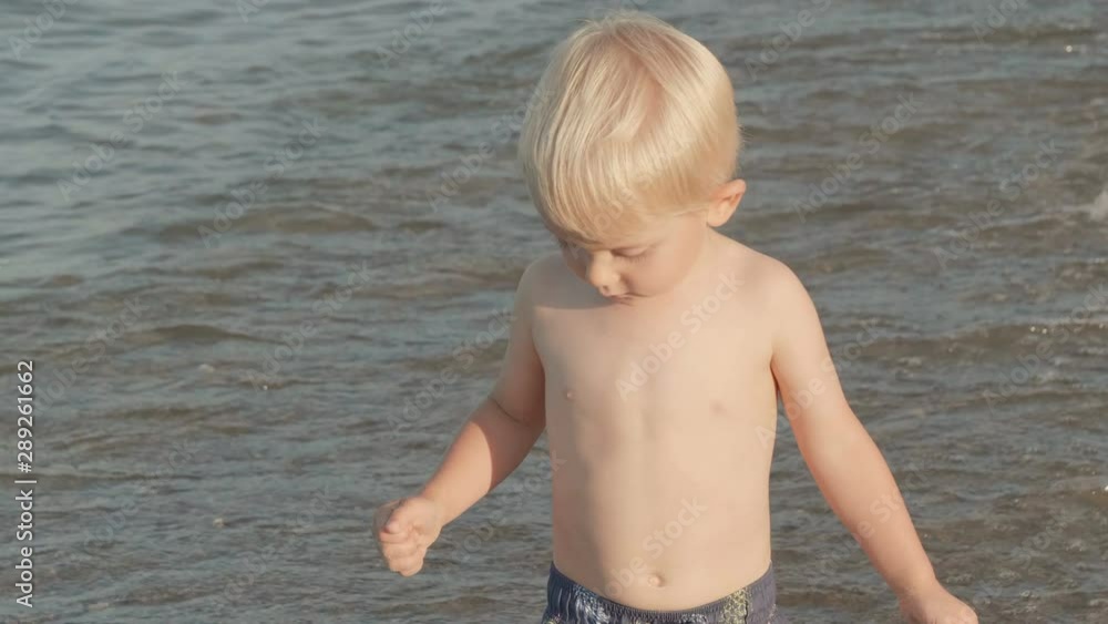 Cute little boy (toddler, two years old kid) walking, running on the beach. Summertime, sunny day, outdoors Cute little boy (toddler, two years old kid) walking, running on the beach. Summertime, sunny day, outdoors