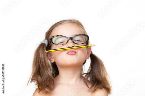 Portrait of a smiling 5 years girl with glasses. White background
