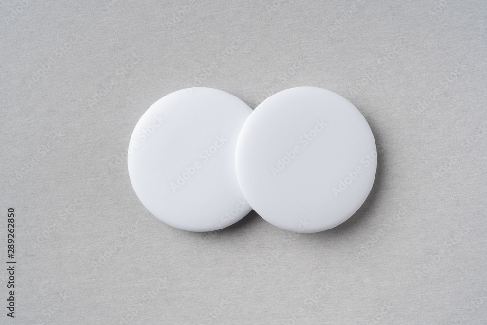 top view of white badge on grey background