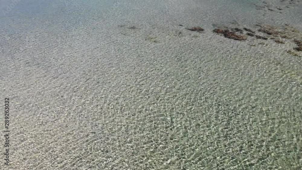 Seawater and pink sand on the Elafonisi lagoon, Crete, Greece. Shallow water on the beach in the summer. Seawater and pink sand on the Elafonisi lagoon, Crete, Greece. Shallow water on the beach in the summer.