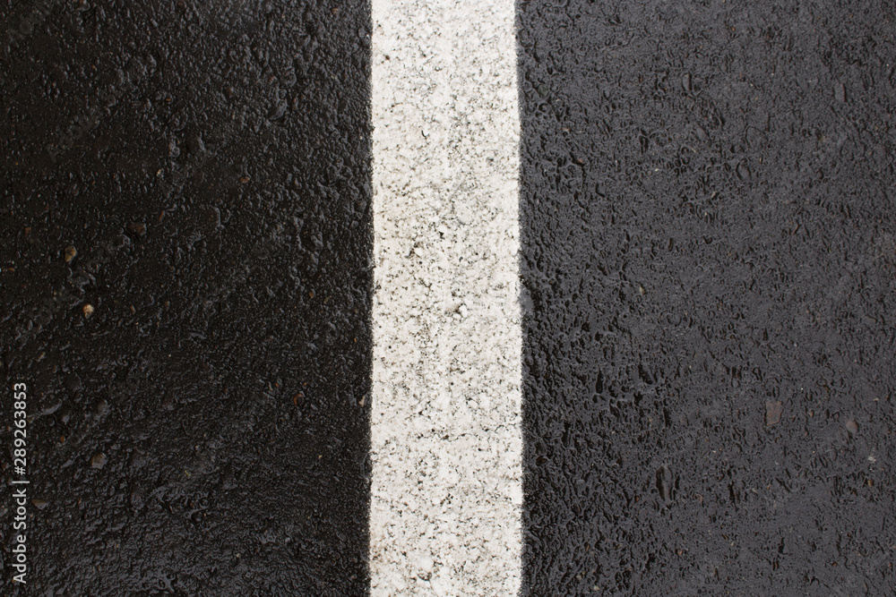 Fototapeta premium Wet asphalt background. Road marking. Black asphalt background.