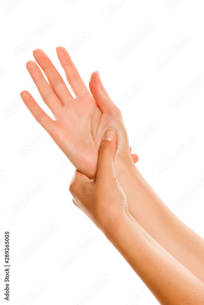 Young woman is massaging her hand. Isolated on white background. Young woman is massaging her hand. Isolated on white background.