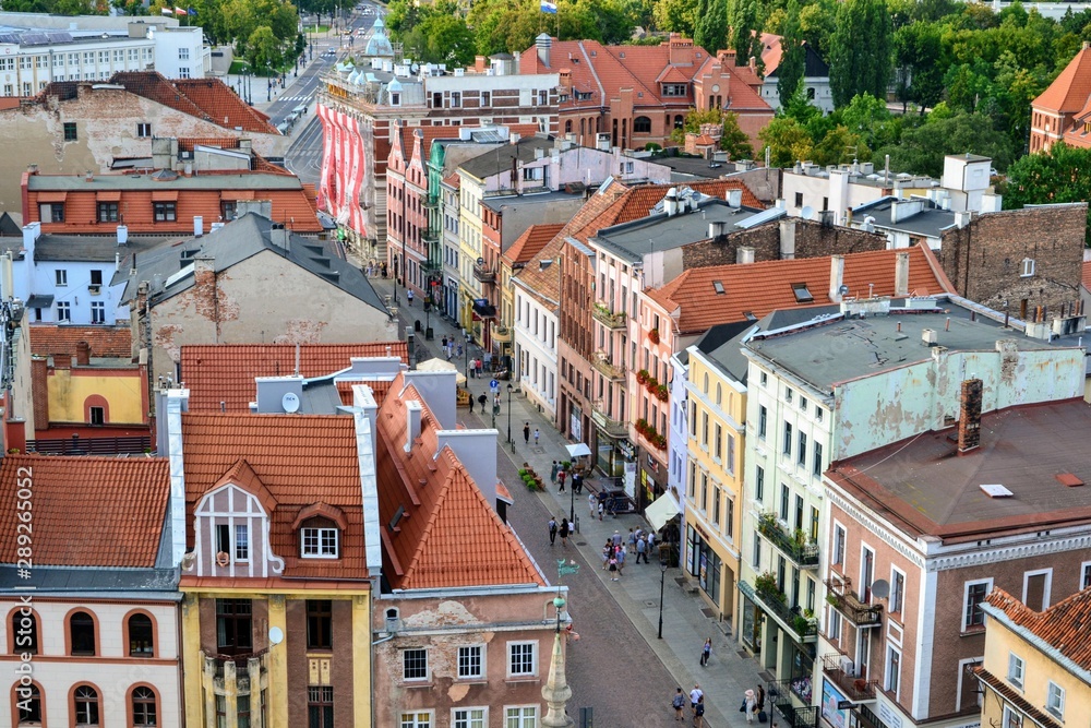 Torun, Poland. Aerial view of the city of Torun. View from the Clock Tower of the Gothic Old Town Hall. Medieval streets of the city with colorful tenement houses and tourists
