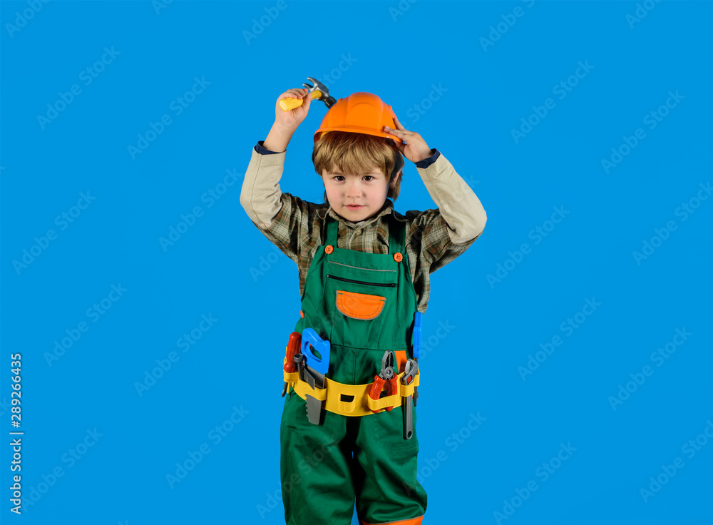 Little repairman with tool belt. Work with tools. Repair. Kid boy as builder or repairer. Little boy in builder's uniform with hammer. Tools for building. Builder boy in helmet and tools. Child game. Little repairman with tool belt. Work with tools. Repair. Kid boy as builder or repairer. Little boy in builder's uniform with hammer. Tools for building. Builder boy in helmet and tools. Child game.
