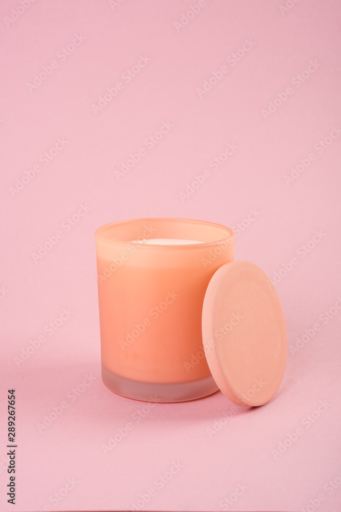 Candle in orange glass with lid studio shot mock-up Candle in orange glass with lid studio shot mock-up