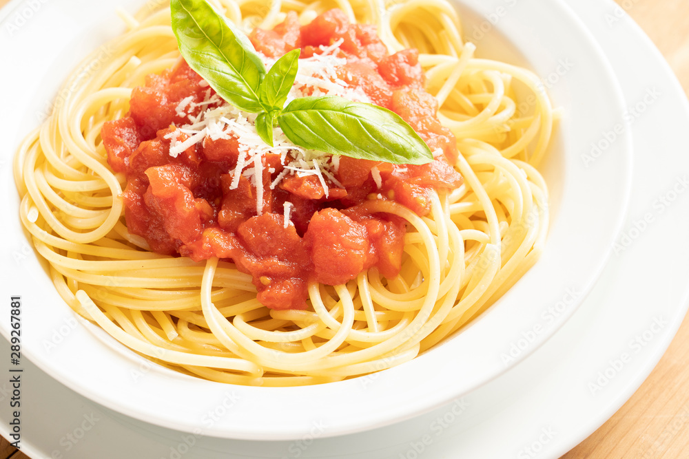 close up on dish with spaghetti tomato and basil close up on dish with spaghetti tomato and basil