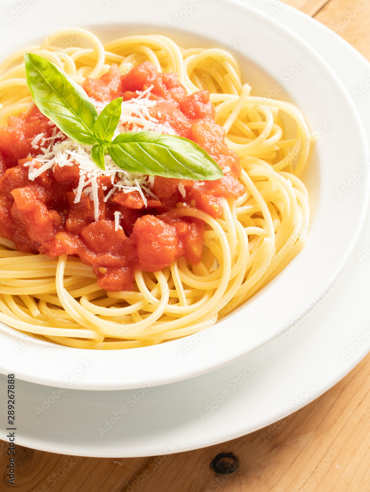 close up on dish with spaghetti tomato and basil close up on dish with spaghetti tomato and basil