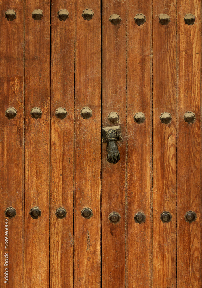 Ancient Wooden Door with Rivets and Door Knocker Ancient Wooden Door with Rivets and Door Knocker