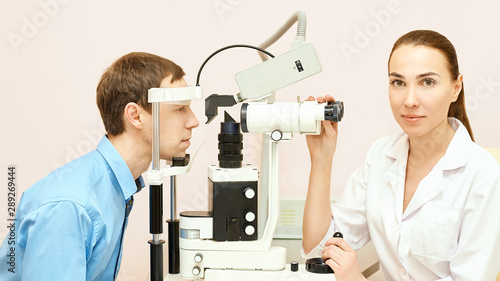 Eye ophthalmologist exam. Eyesight recovery. Astigmatism check concept. Ophthalmology diagmostic device. Beauty girl portrait in clinic. Man patient