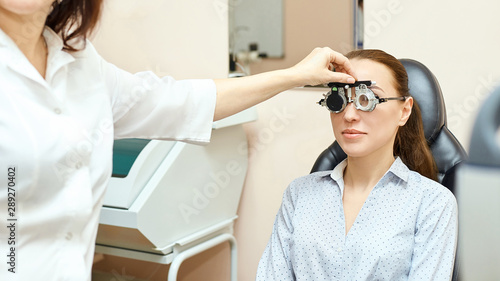 Eye ophthalmologist exam. Eyesight recovery. Astigmatism check concept. Ophthalmology diagmostic device. Beauty girl portrait in clinic photo