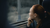 Girl looks out the train window