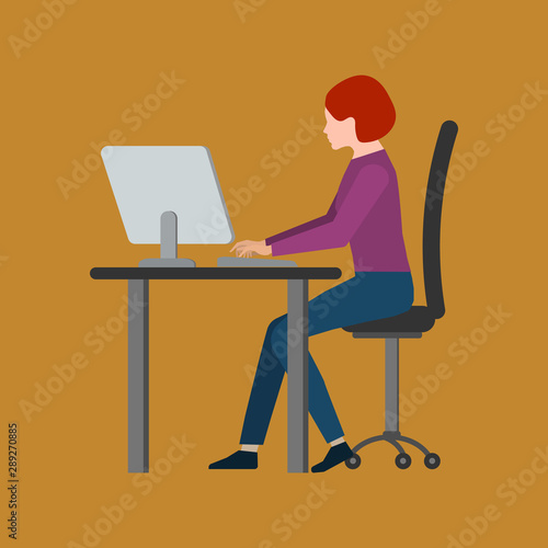 Young woman sitting in front of the computer and working